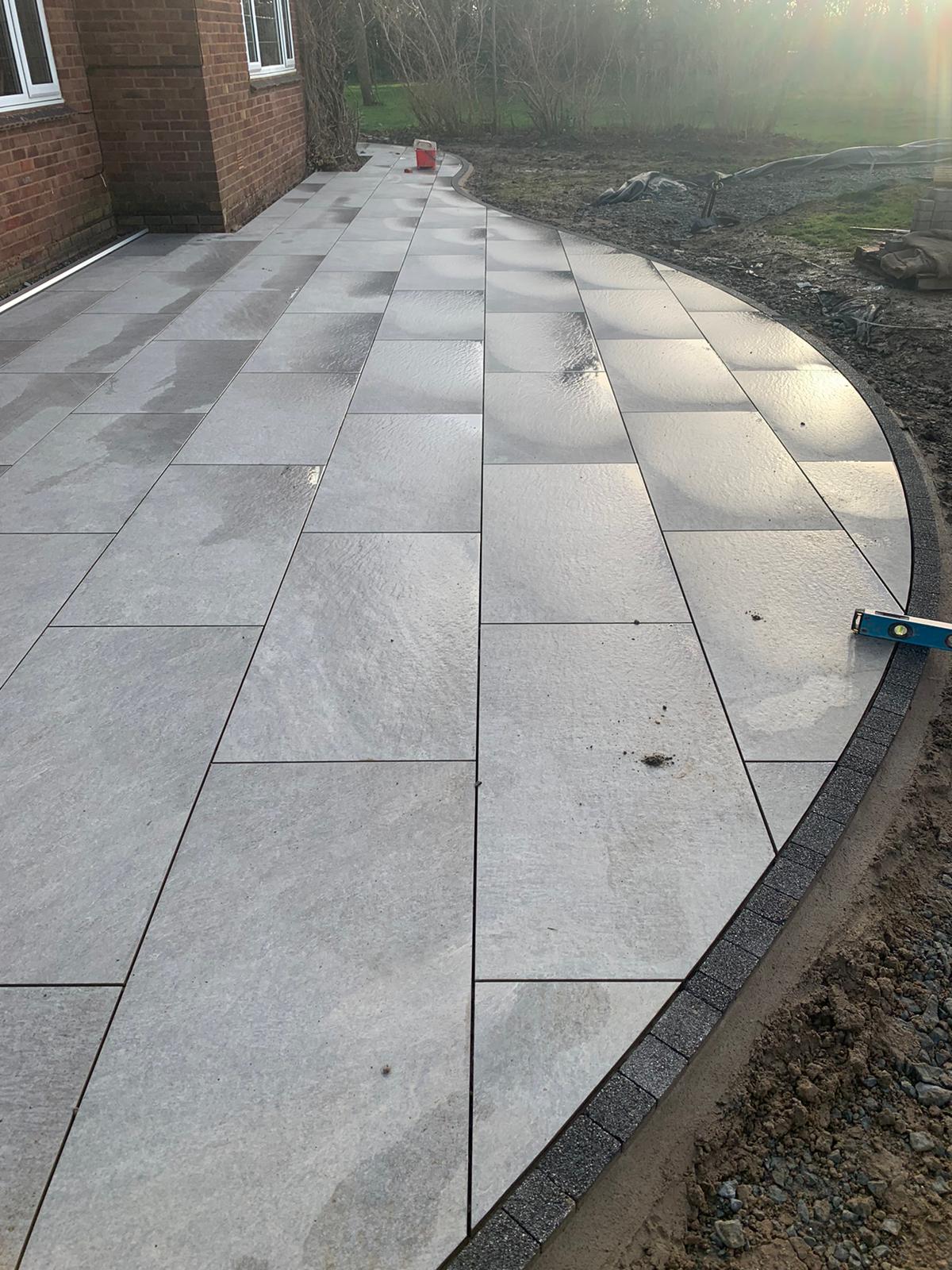 The Old Orchard - High shine stone tiles laid for patio