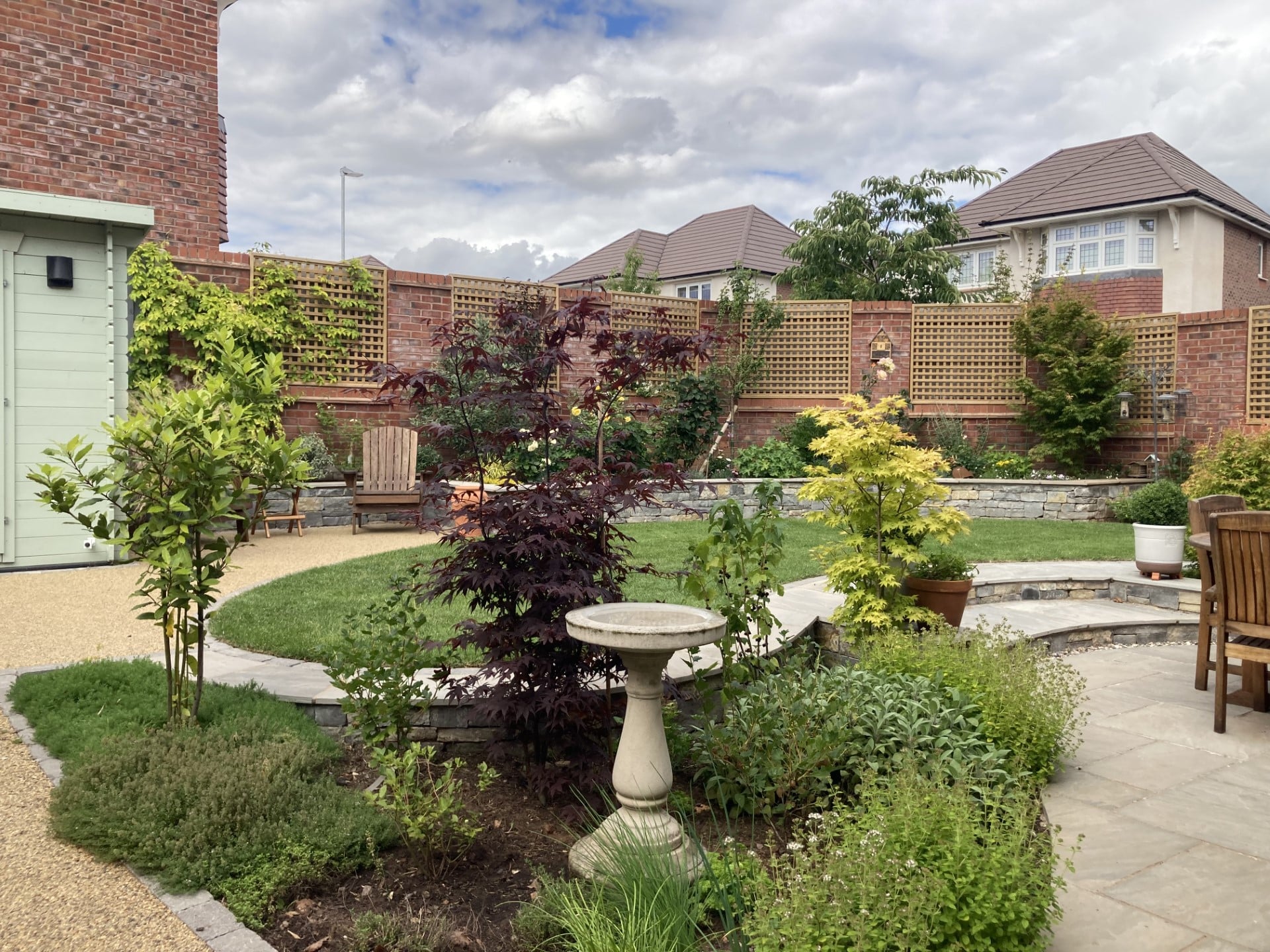 Boomerang Lawn - After - chequered fencing and raised flower beds