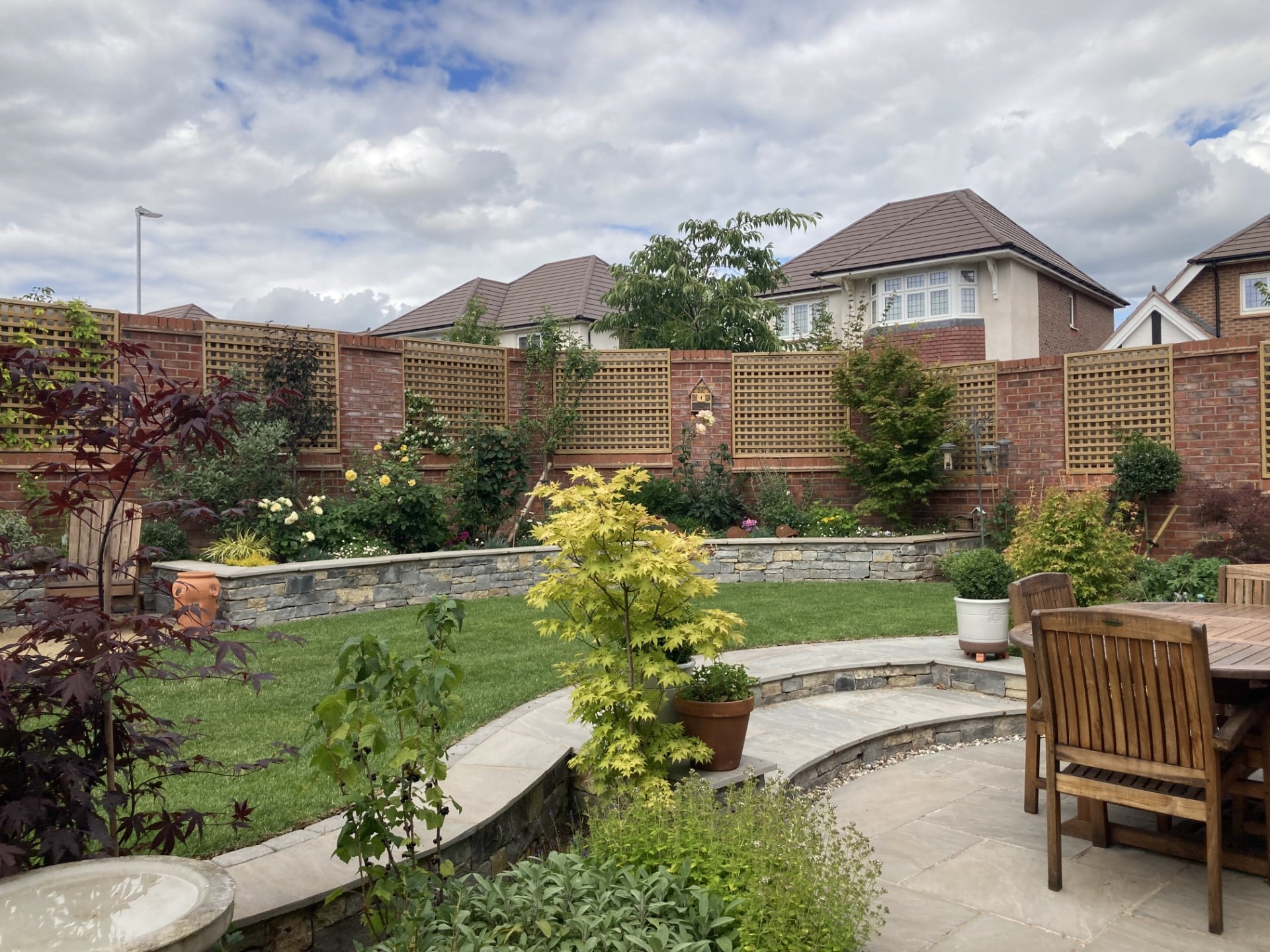 Boomerang Lawn - Raised beds and grass with outdoor seating patio