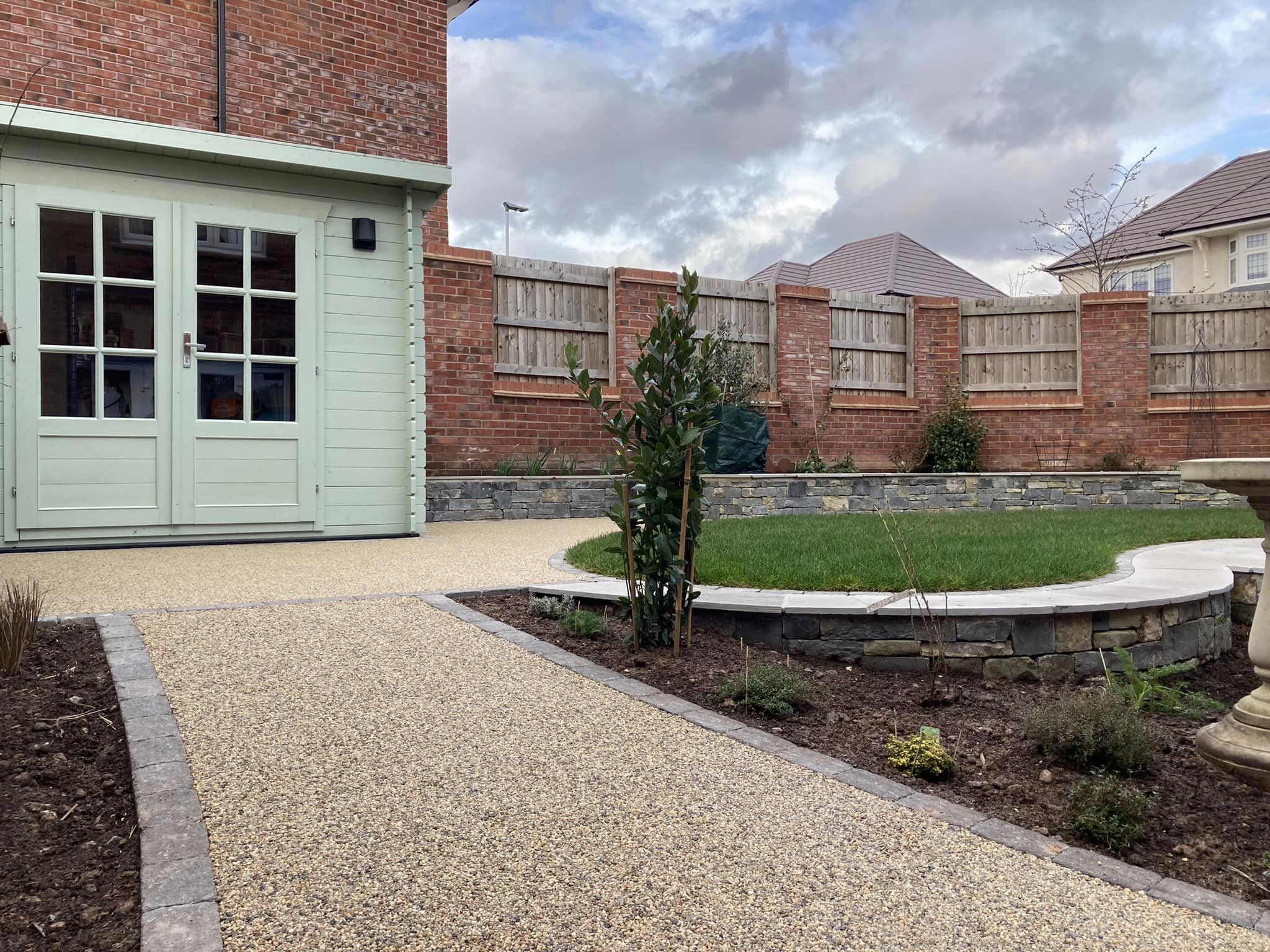 Boomerang Lawn - after - closed up of shed and stone pathway